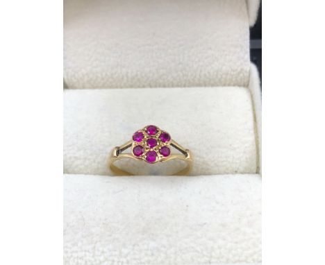 A VINTAGE RUBY CLUSTER RING. UNHALLMARKED, ASSESSED AS 15ct GOLD. FINGER SIZE J. WEIGHT 1.49grms. 