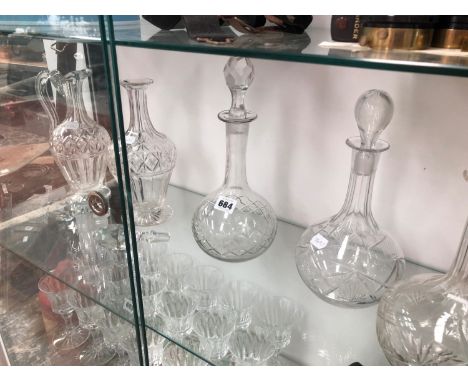 A PAIR OF DECANTERS, ANOTHER GLOBE AND SHAFT DECANTER TOGETHER WITH A CLARET JUG