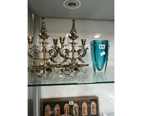 A PAIR OF BRASS NEOGOTHIC TWO LIGHT CANDELABRA TOGTHER WITH A WATERFORD BLUE GLASS VASE