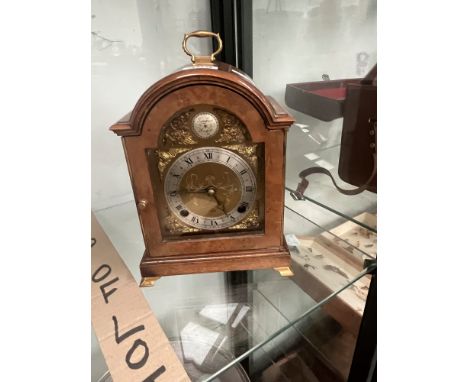 A WALNUT CASED ELLIOTT MANTEL CLOCK STRIKING ON A BELL