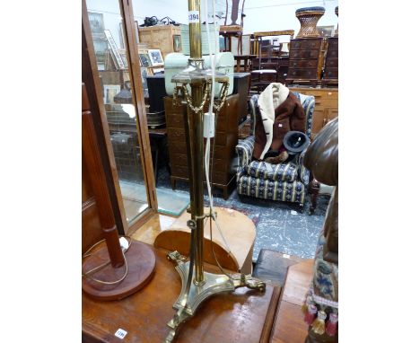 AN EDWARDIAN BRASS STANDARD LAMP.