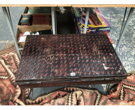 AN OFFICERS TIN TRUNK MOUNTED AS A COFFEE TABLE