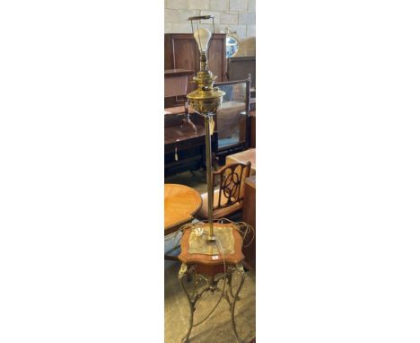 An Edwardian brass lamp standard with table baseCONDITION: Late fitted for electricity, the central metal stem is slightly wo