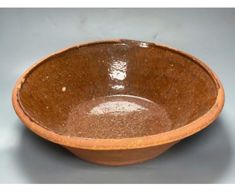 A 19th century Sussex terracotta basinCONDITION: General wear and surface scuffs, minor blisters to glaze, largest approx. 10