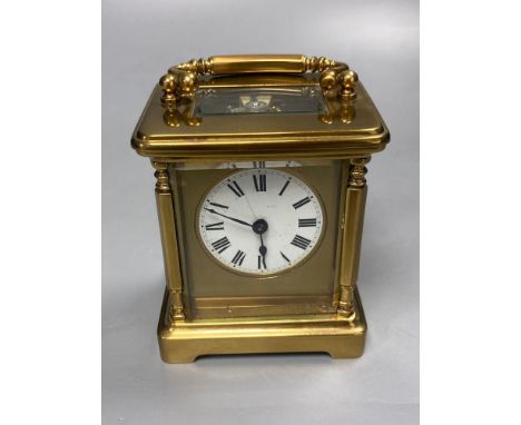 A late 19th century French brass carriage timepiece, 13cm high to handleCONDITION: The white enamel face has a very fine crac