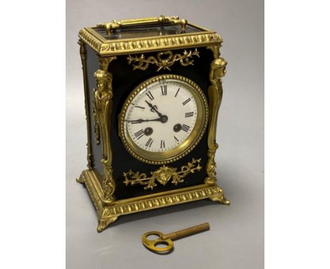 A French ebonised mantel clock with cast brass mounts, 9cm convex enamel dial, bell striking movement, height 27cm incl. hand