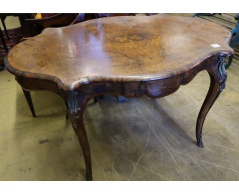 A Victorian figured walnut centre table of serpentine form, with ormolu mounted cabriole legs, width 130cmCONDITION: Overall 