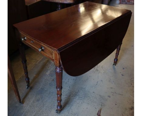 A Regency mahogany sofa table, with D shaped flats and frieze drawer on turned and fluted tapered legs, fitted brass castors,