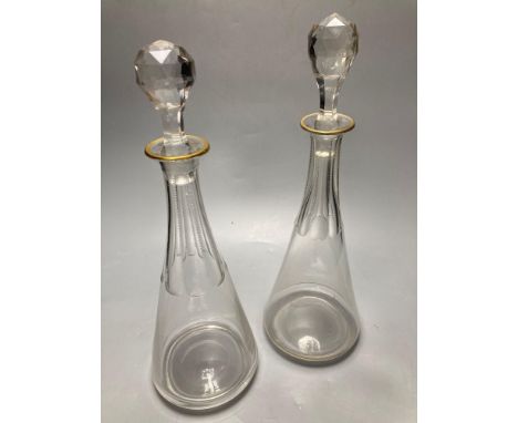 A pair of tall Bohemian cut glass decanters with faceted stoppers, unsigned, 35cmCONDITION: One decanter with narrow gilt bor
