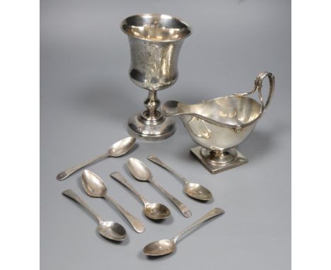 A George V silver sauceboat, a French white metal goblet(repaired) and seven assorted 19th century silver teaspoons, gross 11