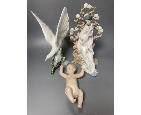 A Lladro figure of a geisha, 30cm high and another of a seagull, 29cm high and a Nao figure of a baby, length 21cmCONDITION: 