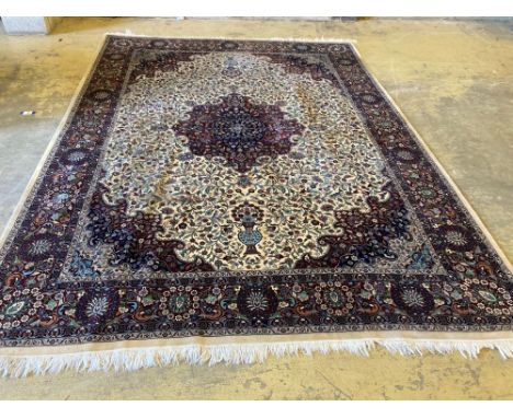 A large Persian cream ground carpet, 280 x 387cmCONDITION: Dirty in places, brown staining in one quarter, patch of staining 