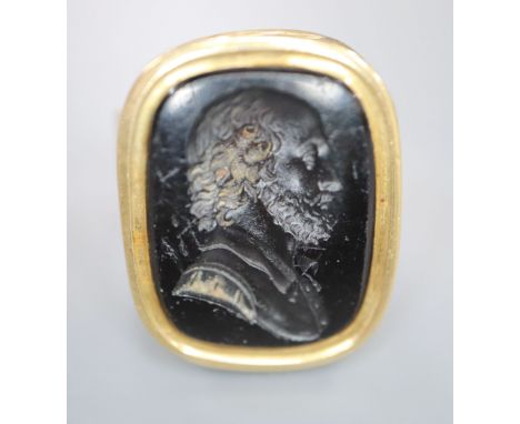 A 9ct and black onyx? intaglio ring, carved with the bust of a gentleman to sinister, size R/S, gross 16.2 grams.CONDITION: S