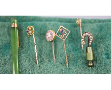 Five assorted Edwardian yellow metal and gem set stick pins, including 'pegasus' cameo and ruby, sapphire and diamond clover 