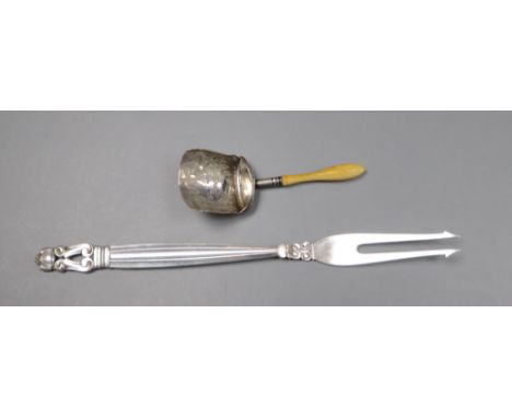 A 1950's Georg Jensen sterling pickle fork and a George III ivory handled silver caddy spoon.CONDITION: The silver has 2 smal