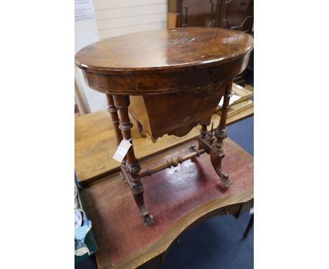 A Victorian inlaid walnut work table, with oval top, width 60cmCONDITION: Repolished at some point and now a dark treacle ton