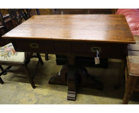 A Gothic style pitch pine two drawer side table, width 100cm depth 55cm height 83cmCONDITION: Of good dark even colour except