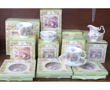 A Royal Doulton Brambly Hedge teapot, milk and sugar and six cups, saucers and plates, boxed