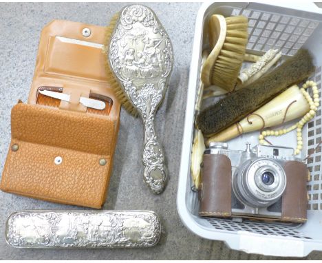 A silver backed comb and brush, a camera and bone items including a necklace