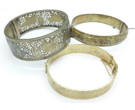 Two silver bangles and one other bangle with pierced elephant decoration