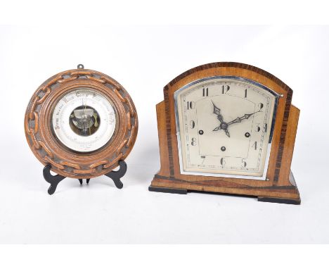 An oak-framed aneroid barometer, late 19th, early 20th, century12cm white dial with bevelled glass, the oak frame with carved