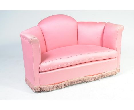 A 1930's Art Deco two seater sofaWith a five panel angled back enclosing a sprung seat above a tasselled apron, 130cm wide.