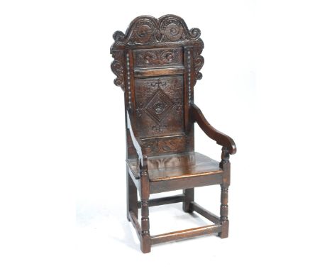 A fine late 17th century oak Lancashire Wainscot chairThe shaped back with a scrolling pediment above a panel centred with an