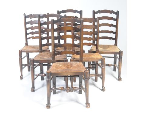 A set of six 18th Century style ladder back kitchen chairs, 20th CenturyEach chair with a five rung back above an envelope ru