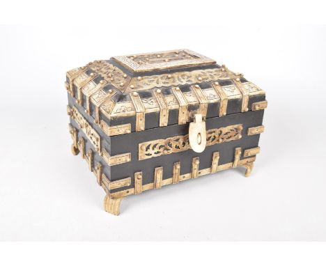 A Japanese carved and inlaid bone casket, early 20th CenturyThe carved and stained wood applied with carved bone mounts and f