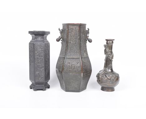 A Collection of two metalwork and one resin Chinese vases, early 20th Century The first of bottle vase cast in high relief wi