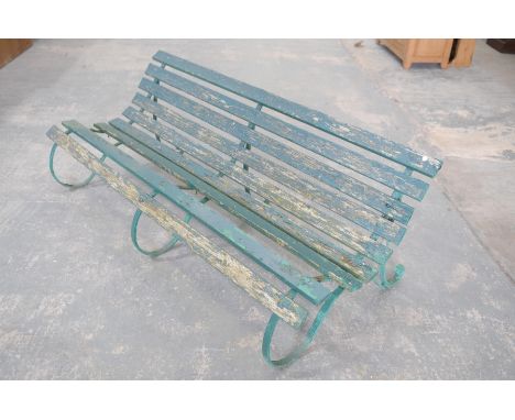 An early 20th century painted hardwood and iron garden benchThe bench of low slung "S" form constructed from hardwood slats m