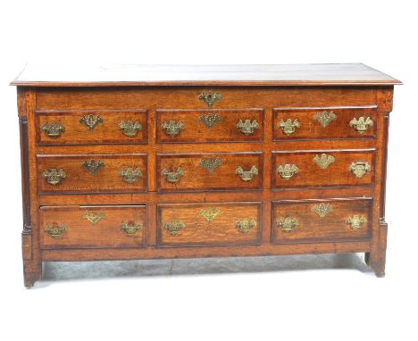 A George III oak and mahogany crossbanded Lancashire mule chestWith a rectangular hinged moulded plank top above an arrangeme