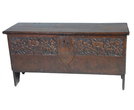 A good 17th century oak six plank coffer Having a rectangular moulded two plank top on later hinges enclosing a fitted candle