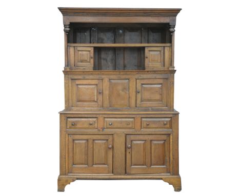 An 18th/19th Century oak highback dresserThe raised back with a moulded cavetto cornice above a single shelf and two small pa