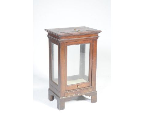 A 19th century mahogany desktop instrument cabinetHaving a hinged rectangular cover above a sliding glazed front panel and hi