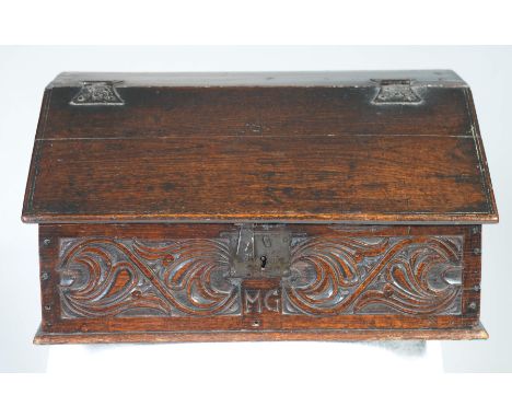 A fine late 17th century oak bible boxThe fall front with iron butterfly shaped hinges enclosing a vacant interior above a fr