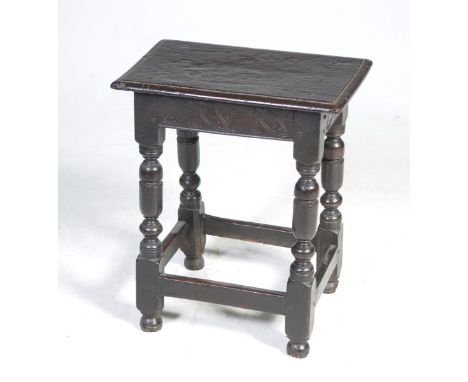 A 17th/18th century oak joint stoolWith a rectangular moulded top above a frieze incised with a repeating leaf design, suppor
