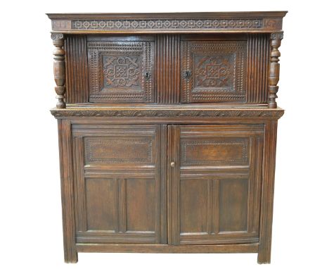 An exceptional early 17th century James I carved oak court cupboardHaving a frieze carved with a geometric alternating design