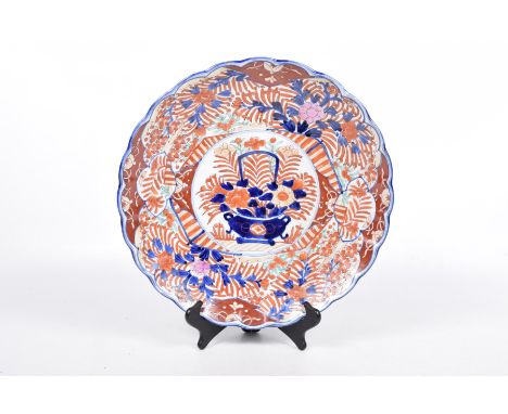 A Japanese Imari charger, 20th CenturyWith a central circular panel depicting a cobalt blue vase of blooms within a leaf and 