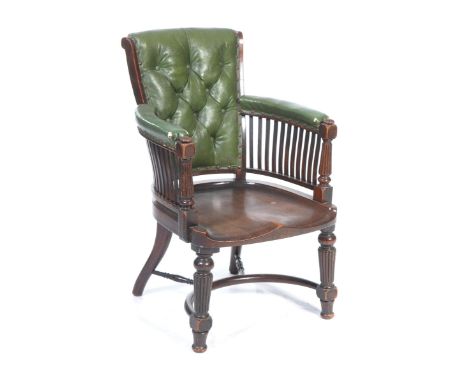 A Victorian mahogany and leather library chairWith a padded button back above curved and padded outswept arms raised upon rai