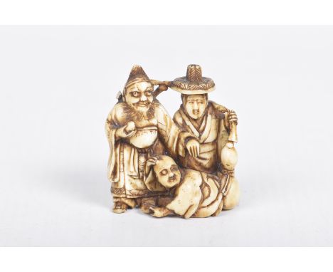 A Japanese carved ivory netsuke, late Meiji periodCarved as three immortal figures, each with a symbolic attribute, 4x3.5cm, 