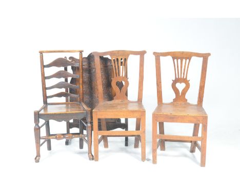A pair of 19th Century country chairsPossibly fruit wood, each with a pierced splat and a heart shaped aperture above a board