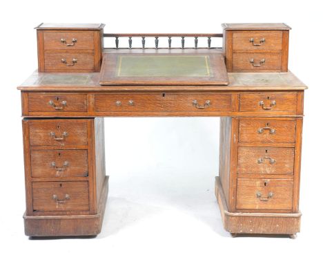 A Victorian oak clerks deskThe architectural raised back with a central gallery flanked by two banks of small drawers, above 