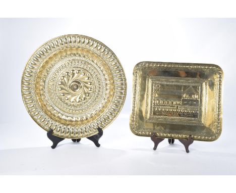 An Eastern brass plaque and a second circular brass plaqueThe rectangular Eastern brass plaque with rounded corners with a ce