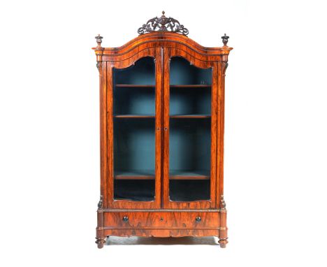 A stunning French rosewood display cabinet, mid to late 19th centuryWith a carved open scrolling foliate crest flanked by two