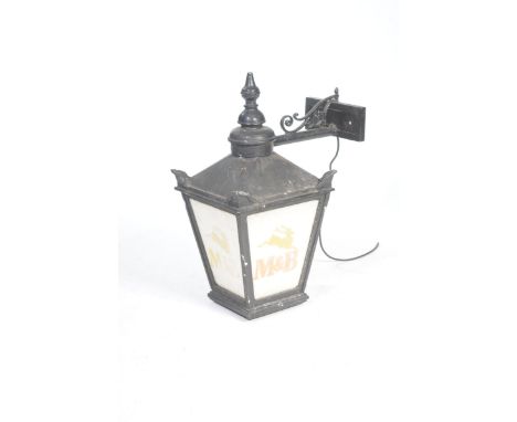 A wall mounted public house lanternWith a tubular wall mounted bracket, the lantern of typical tapering pagoda form with four