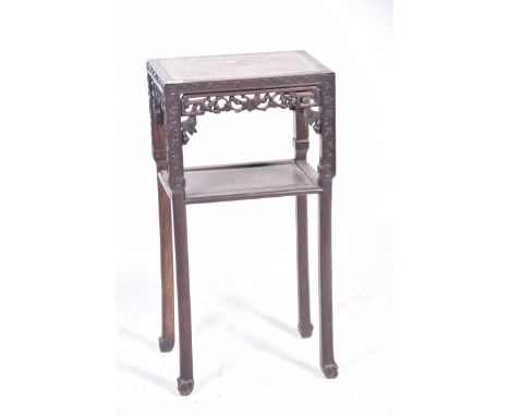 A Chinese Huanghuali style jardiniere stand, Circa 1900The rectangular top inset with marble, with pierced traditional scroll