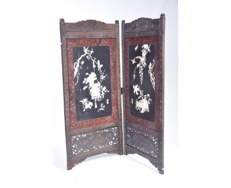 A Japanese red lacquer Shibayami two fold screenEach panel with a frieze carved with flower heads above a lacquered panel app