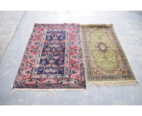 A Caucasian pattern rugWith a central panel on a blue ground adorned with abstract motifs, along with a modern Salome wool ru