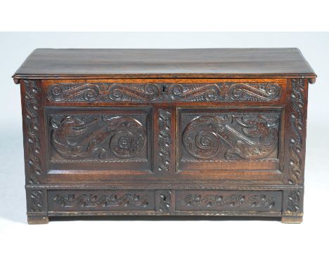 An exceptional 17th century oak blanket chestPossibly Welsh with a rectangular moulded two plank top enclosing a fitted candl
